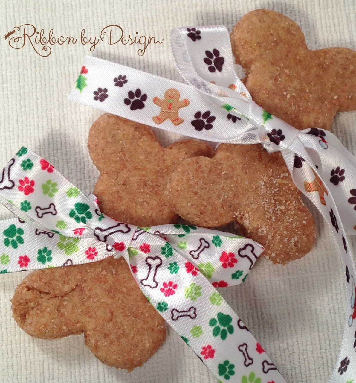 Holiday Dog Bones Ribbon with green and red paw prints on 5/8" white Single Face Satin ribbon